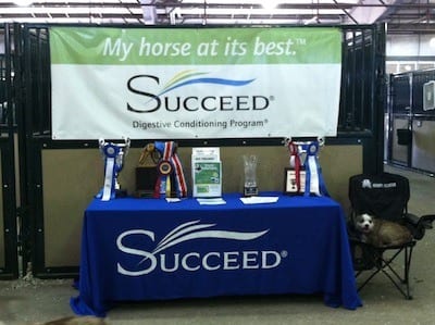 Courtney at the Show Stop Farm stalls with her championship awards